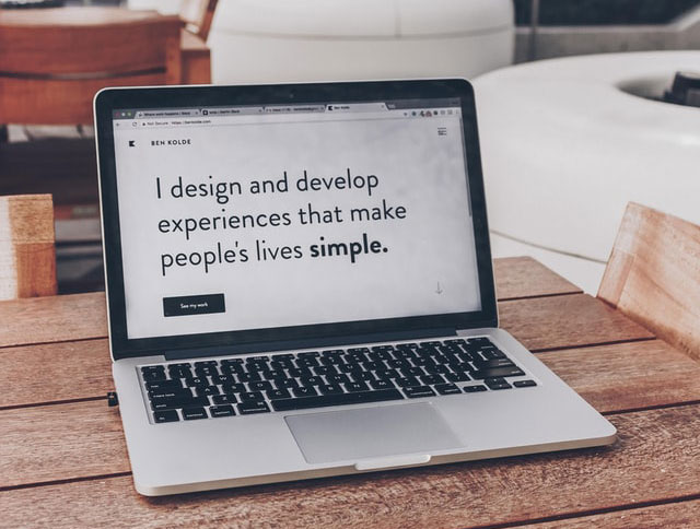 Laptop screen with text: I design and develop experiences that make people's lives simple